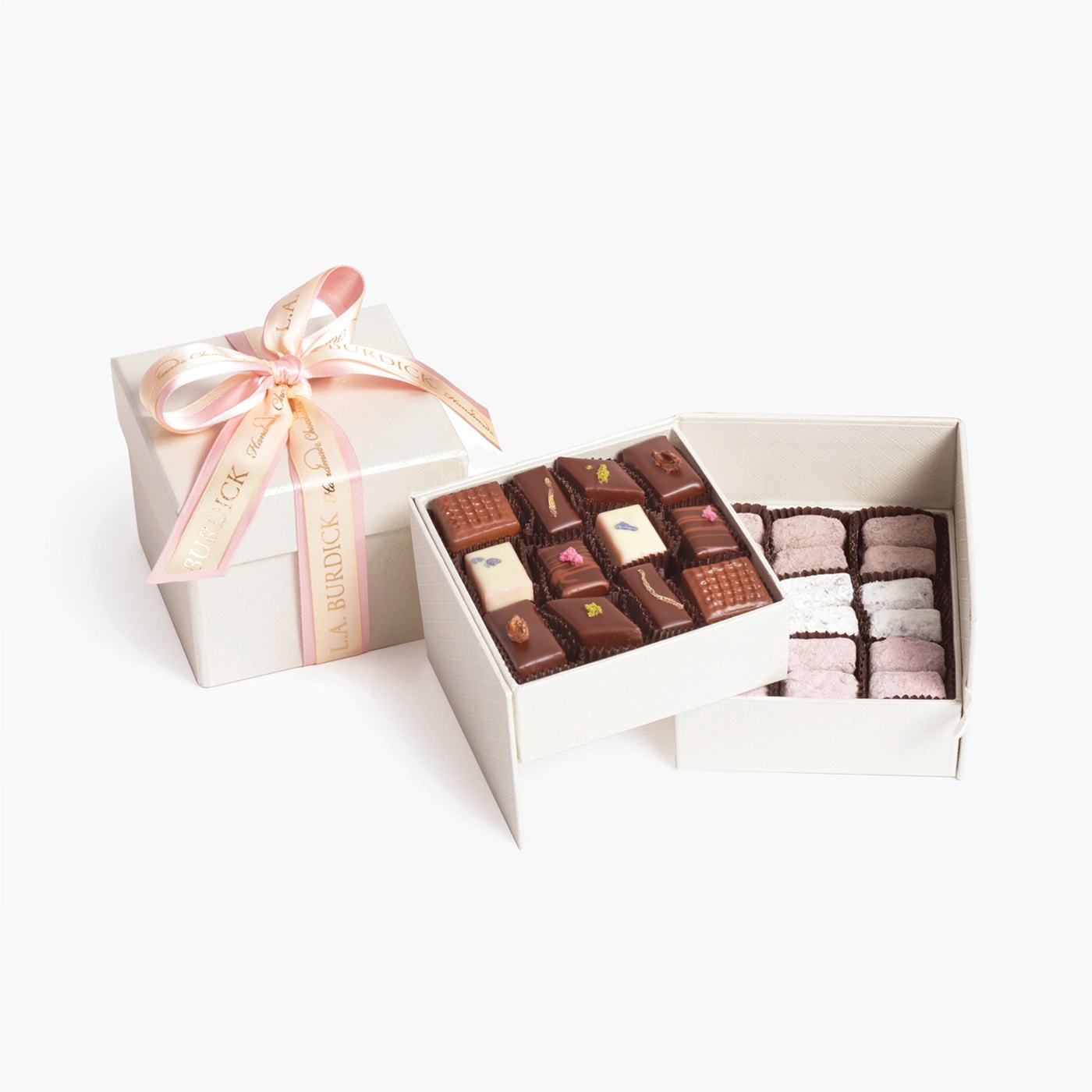 An assortment of handcrafted Strawberry, Blood Orange, Chambord chocolate bonbons and and more in an elegant two-tiered box tied with pink and tan ribbon, perfect fresh spring or Mother's Day gift.